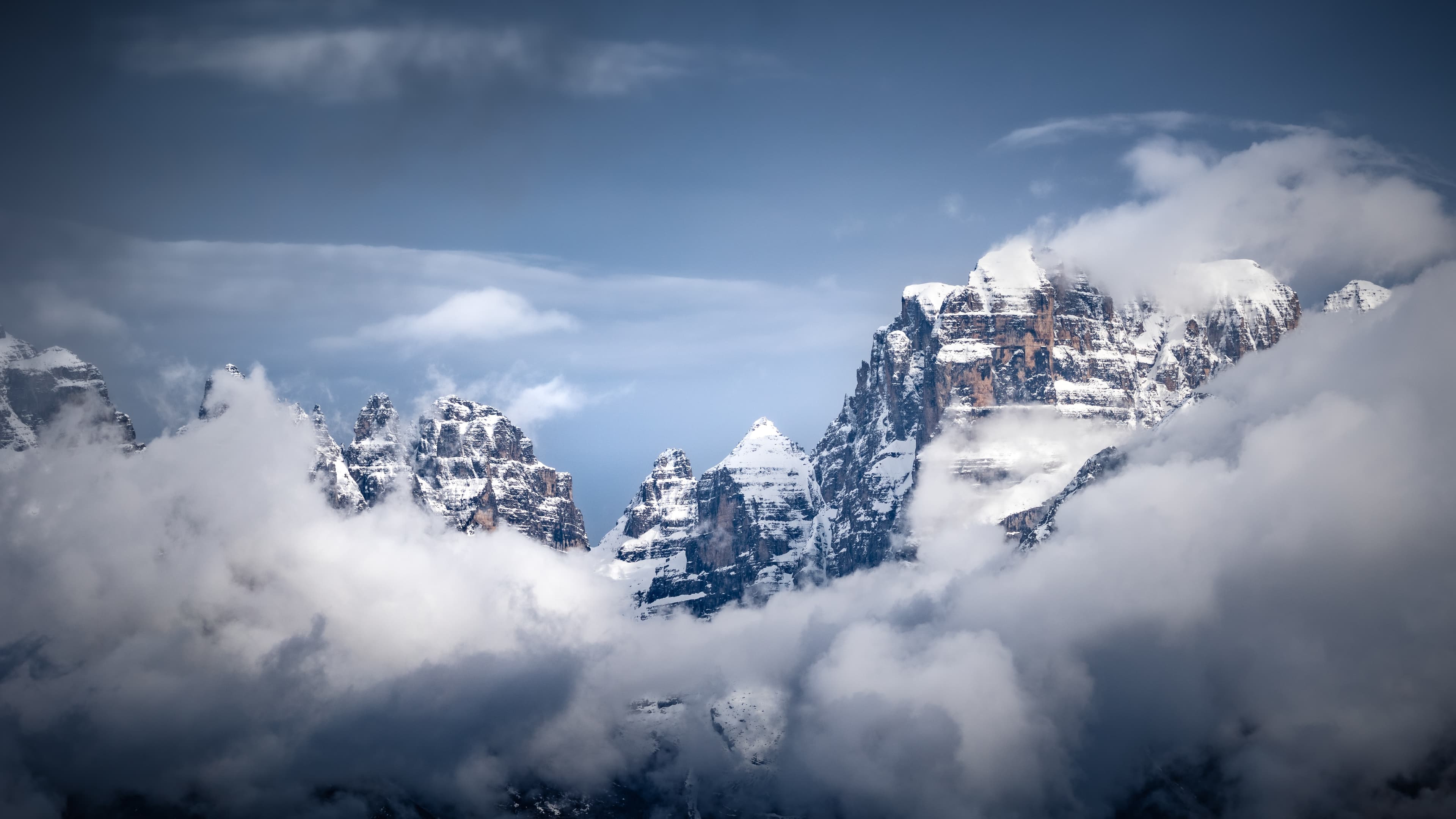 Snowy Italian mountain landscape with clouds rolling in