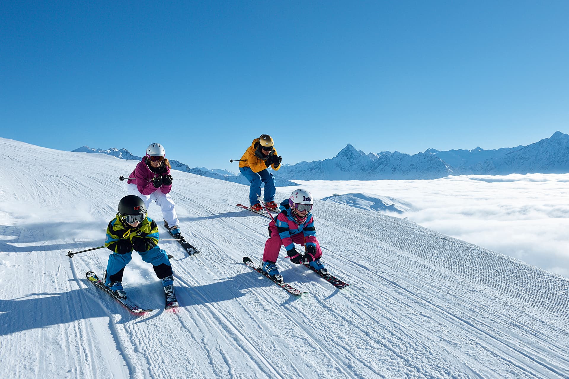 Family skiing down slope